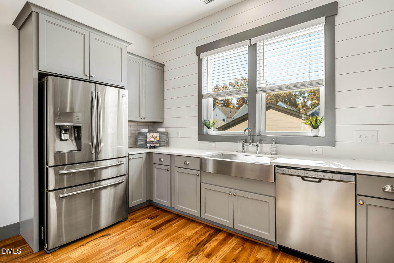 260 Quarter Gate Trace Chapel Hill, NC 27516 - Photo 14 of 68 a kitchen with stainless steel appliances a sink cabinets and a window