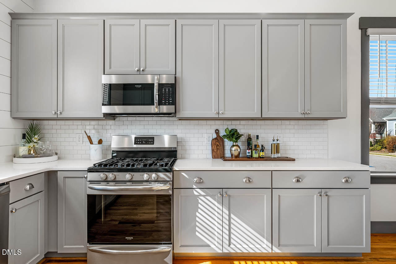 260 Quarter Gate Trace Chapel Hill, NC 27516 - Photo 17 of 68 a kitchen with granite countertop white cabinets and stainless steel appliances