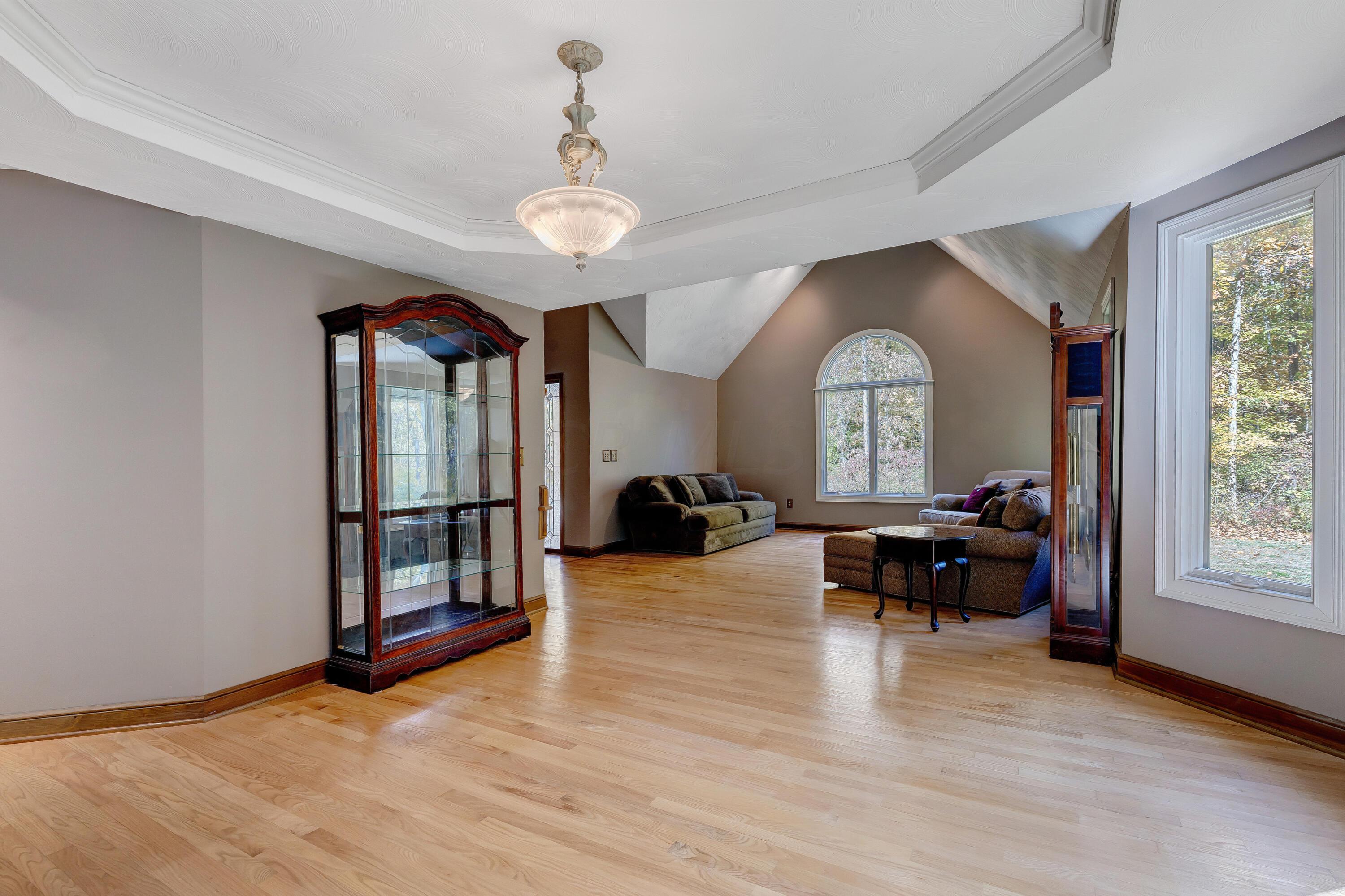 10640 Center Village Road Galena, OH 43021 - Photo 13 of 80 • Hardwood flooring • Taupe painted walls • Tray ceiling • Chandelier