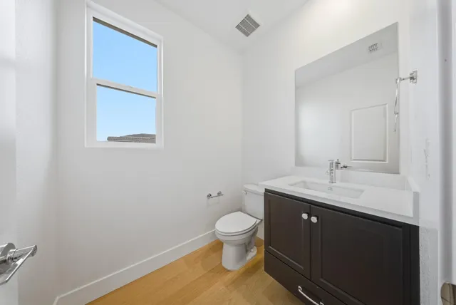 a large kitchen with stainless steel appliances kitchen island granite countertop a large counter top and a stove top oven