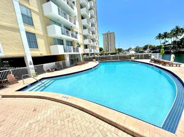 a view of a swimming pool with outdoor seating