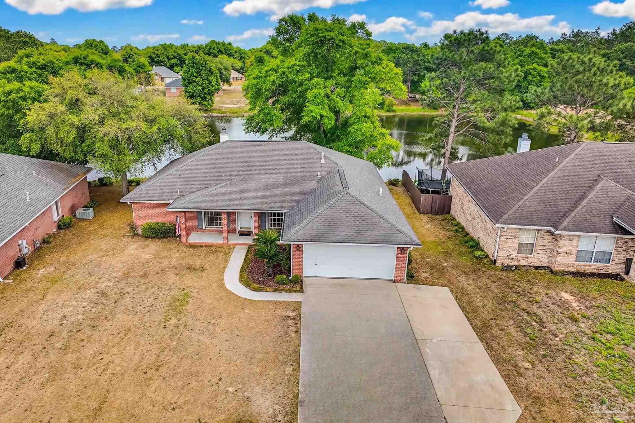 2856 Atoka Trail Crestview, FL 32539 - Photo 1 of 53 an aerial view of a house with garden space and street view