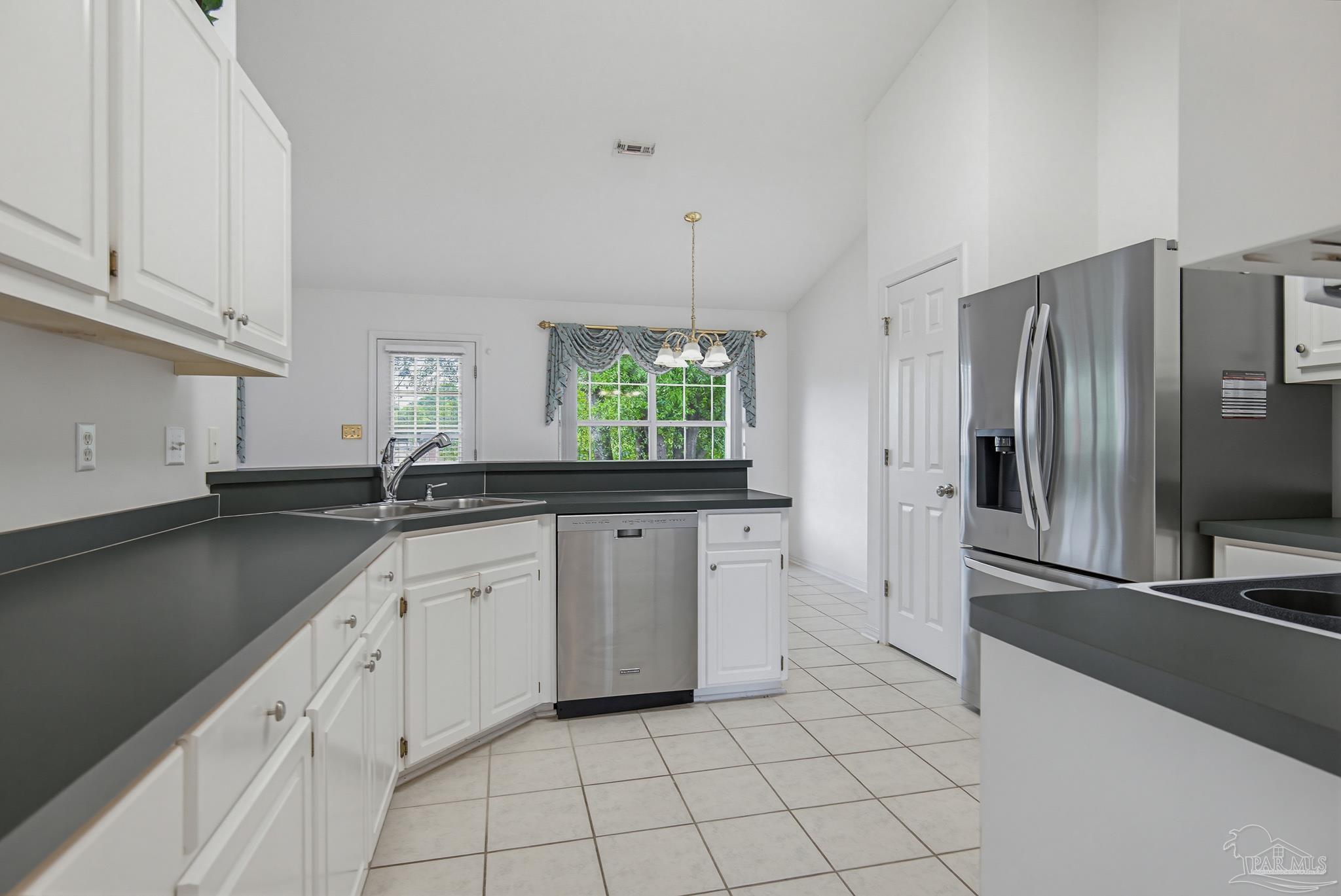 2856 Atoka Trail Crestview, FL 32539 - Photo 16 of 53 a kitchen with appliances cabinets and a sink