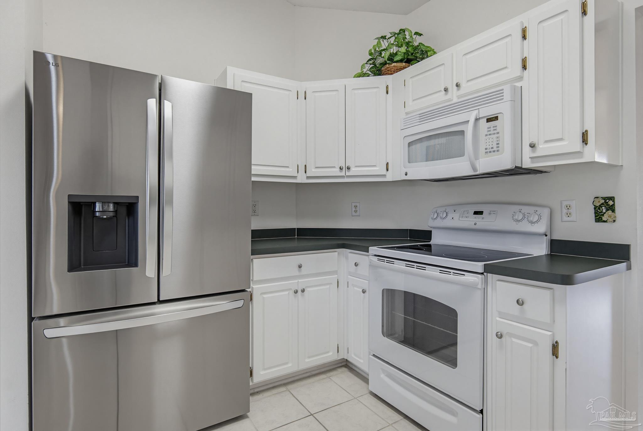 2856 Atoka Trail Crestview, FL 32539 - Photo 17 of 53 a kitchen with white cabinets and white stainless steel appliances
