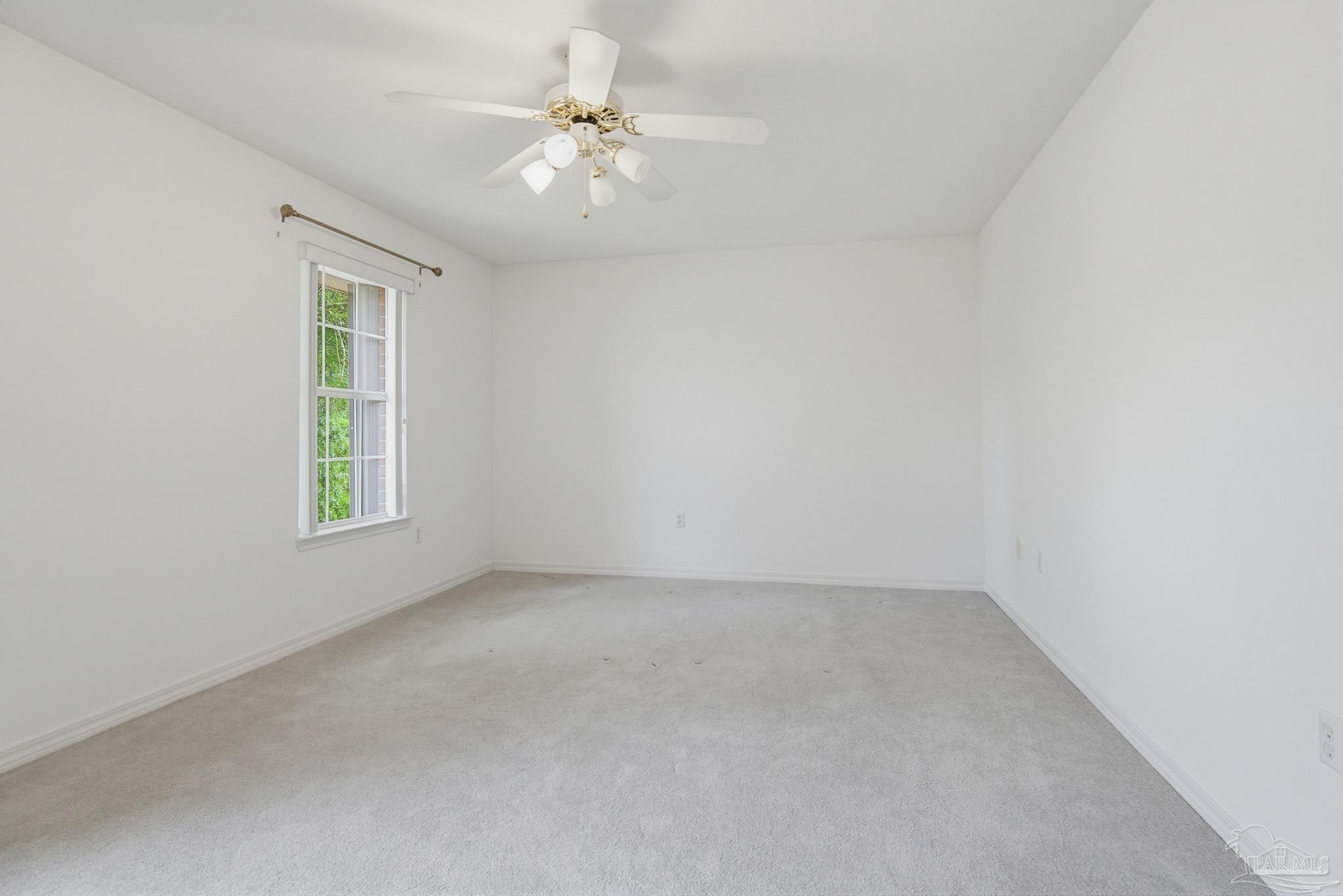 2856 Atoka Trail Crestview, FL 32539 - Photo 27 of 53 an empty room with a chandelier fan and windows
