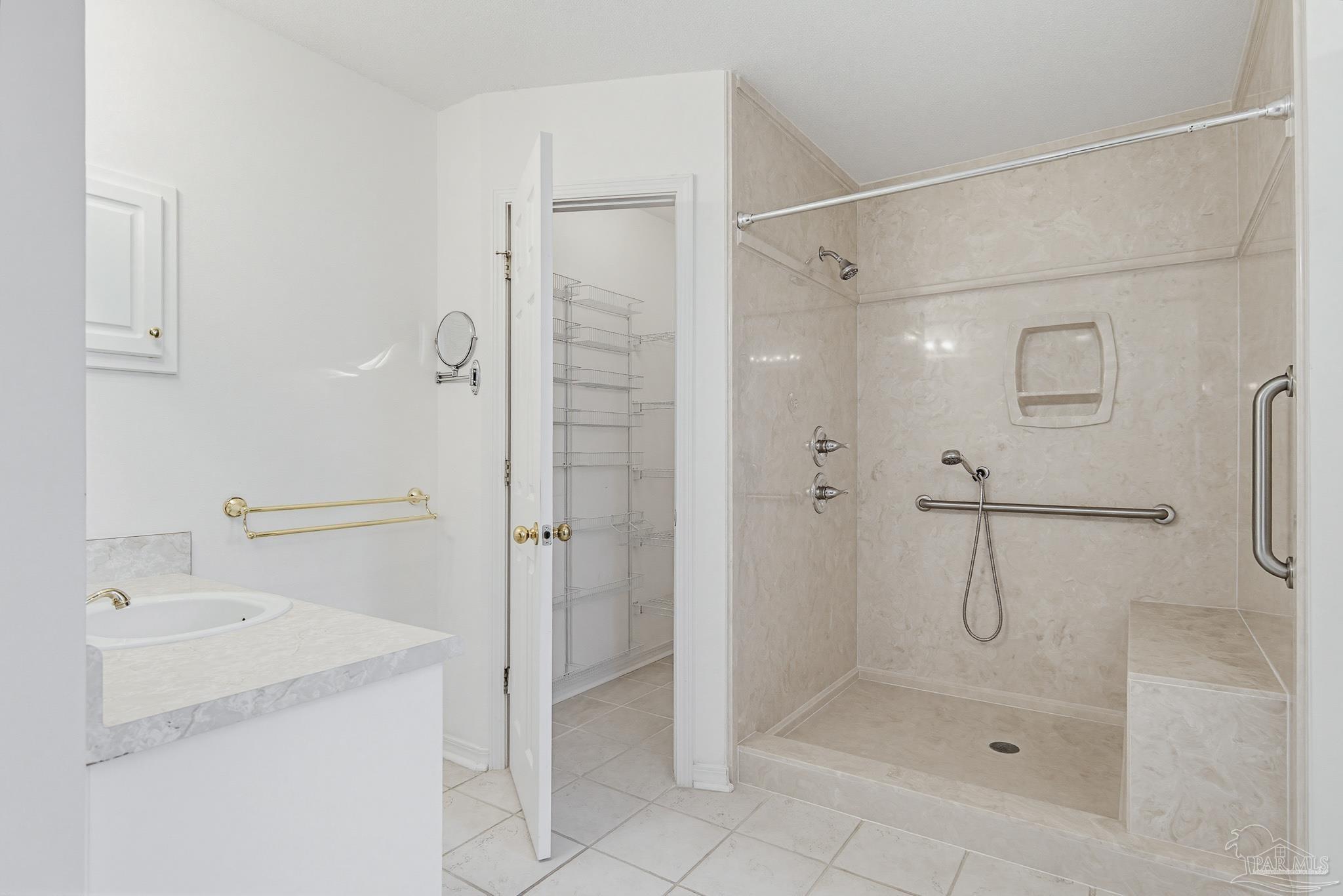 2856 Atoka Trail Crestview, FL 32539 - Photo 32 of 53 a bathroom with a shower sink and mirror