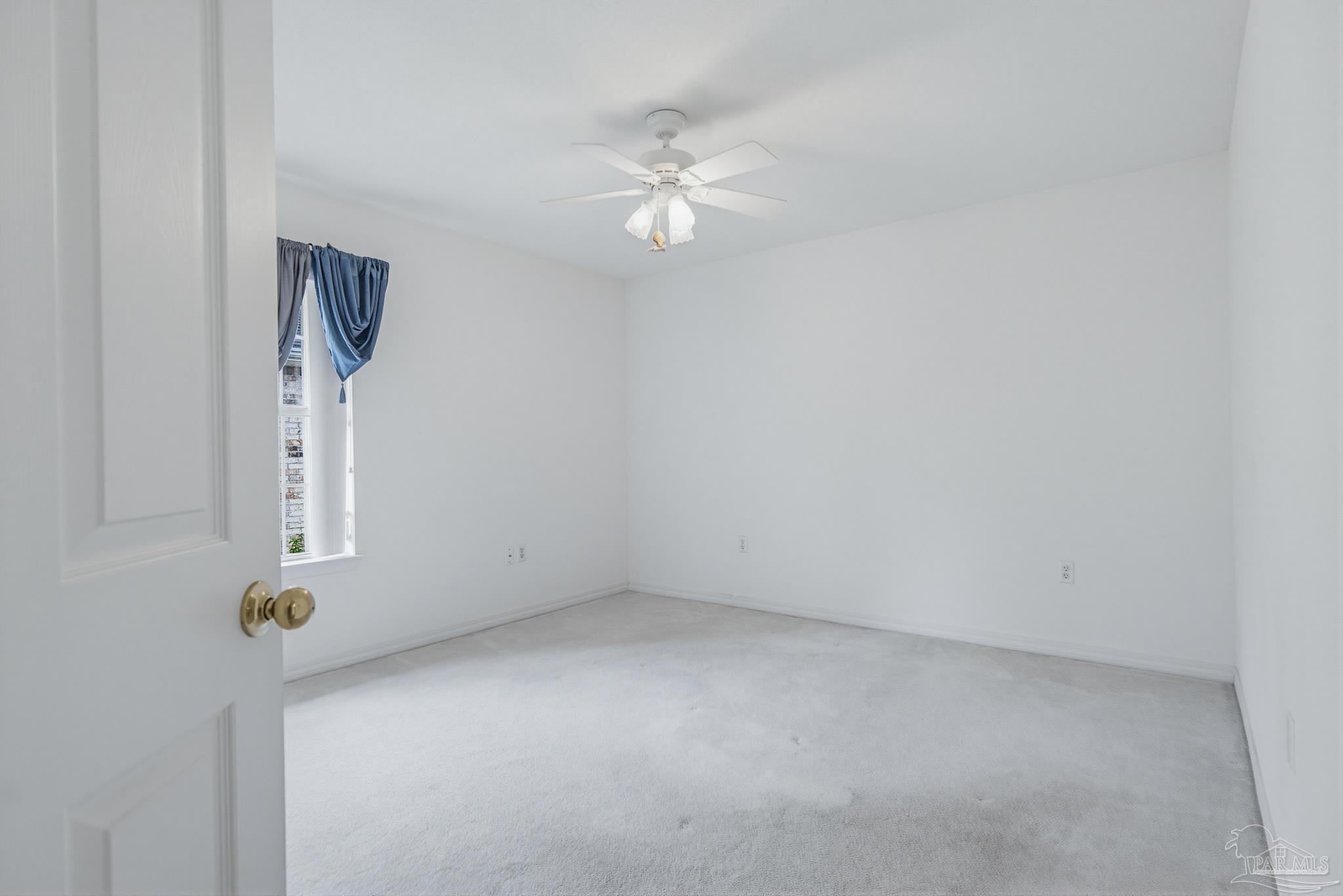 2856 Atoka Trail Crestview, FL 32539 - Photo 43 of 53 an empty room with chandelier fan and windows