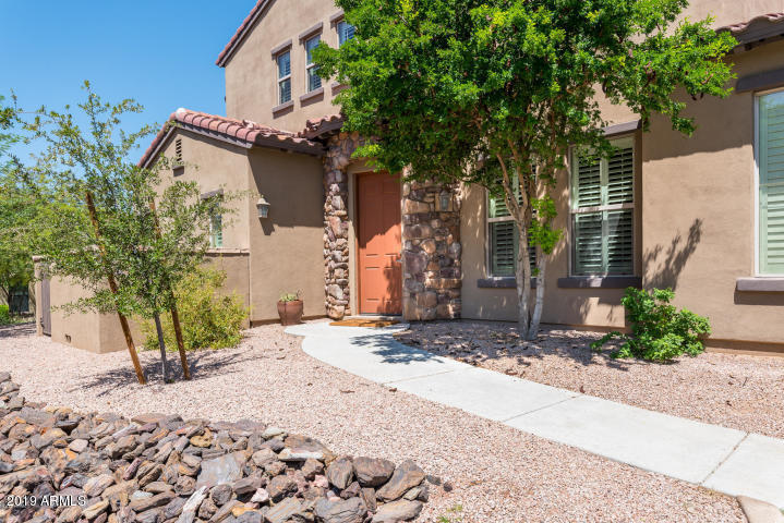 20750 North 87th Street, Unit 1123 Scottsdale, AZ 85255 - Photo 1 of 32 a street view with wooden fence and plants