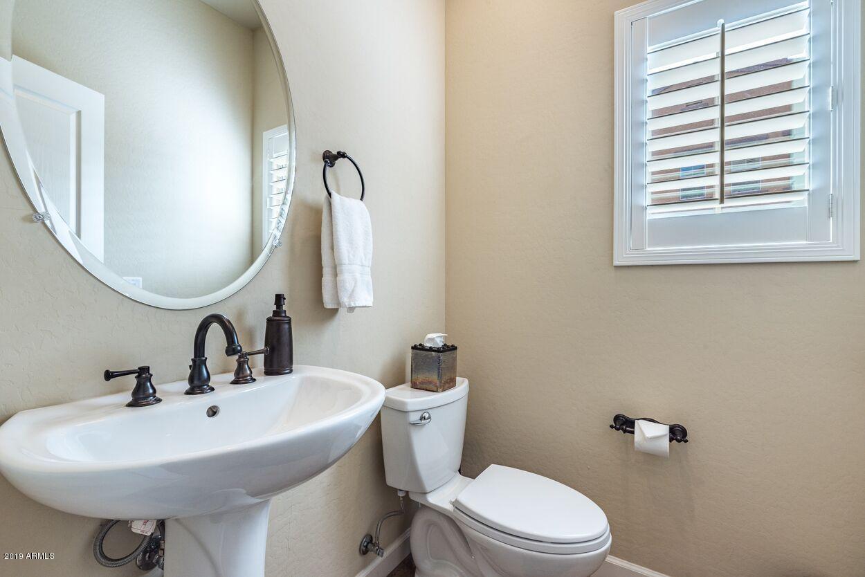 20750 North 87th Street, Unit 1123 Scottsdale, AZ 85255 - Photo 13 of 32 a bathroom with a sink a toilet and mirror