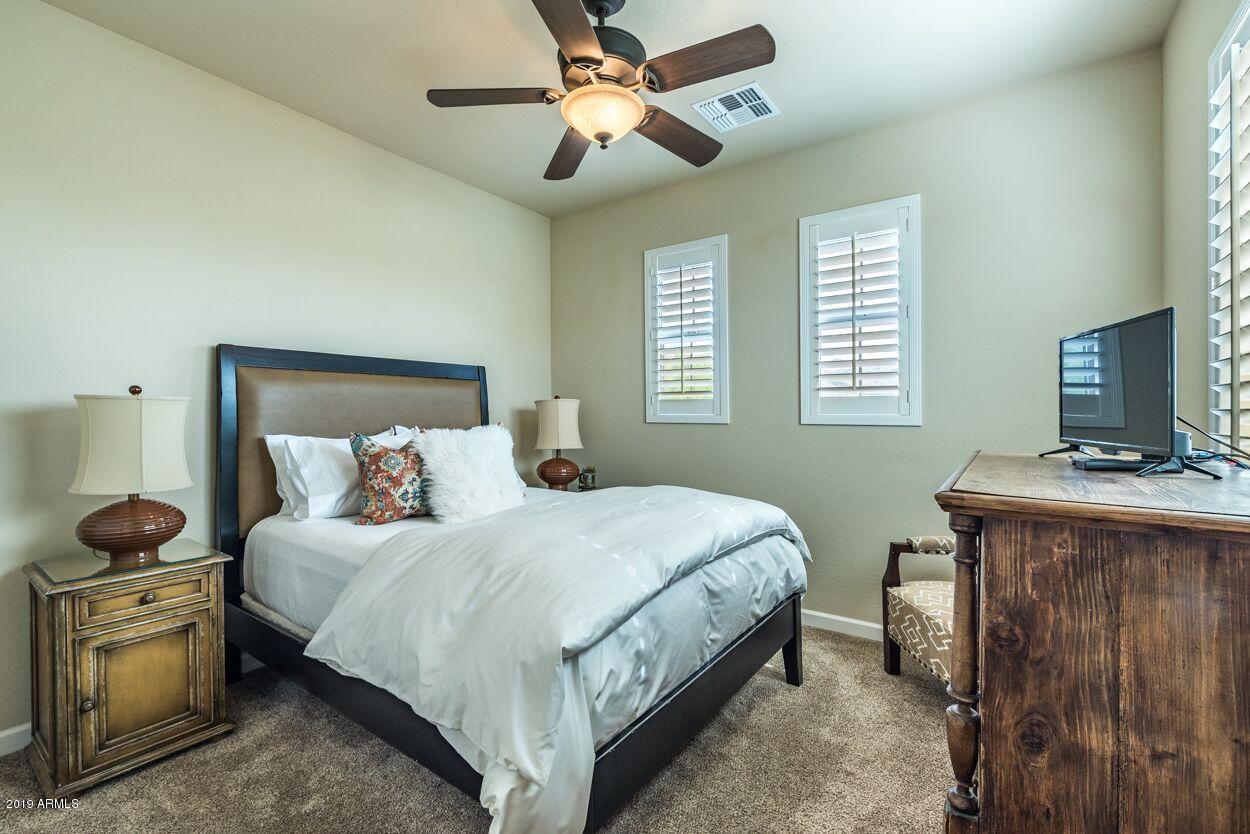 20750 North 87th Street, Unit 1123 Scottsdale, AZ 85255 - Photo 14 of 32 a bedroom with a bed and a tv