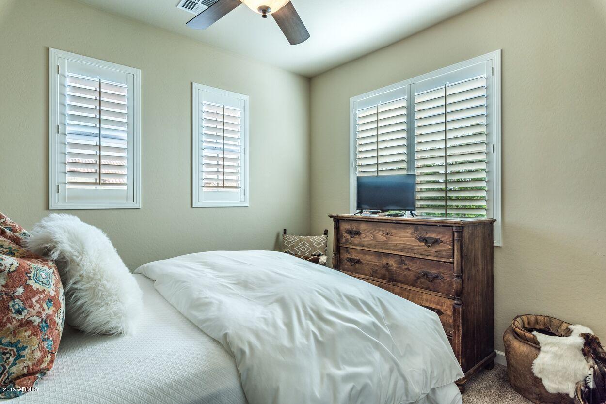 20750 North 87th Street, Unit 1123 Scottsdale, AZ 85255 - Photo 15 of 32 a bedroom with a bed and a window