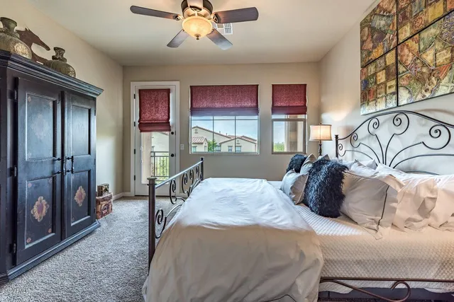 a bedroom with a large bed and a chandelier