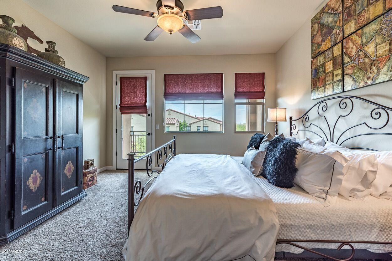 20750 North 87th Street, Unit 1123 Scottsdale, AZ 85255 - Photo 17 of 32 a bedroom with a large bed and a chandelier