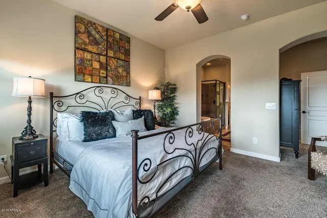 a bedroom with a bed and a chandelier