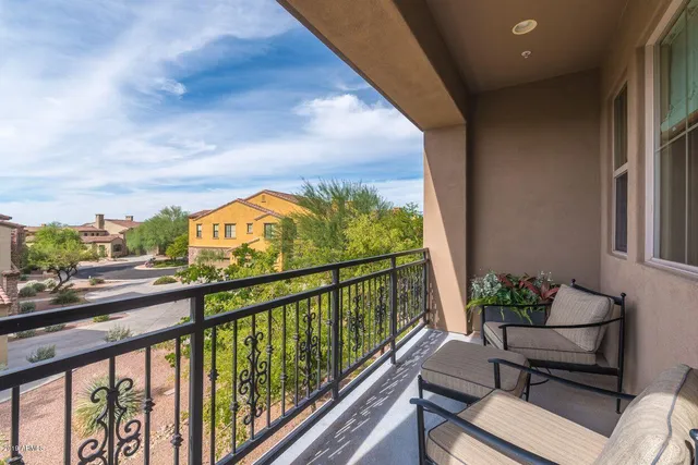 a view of a chairs and table in a balcony