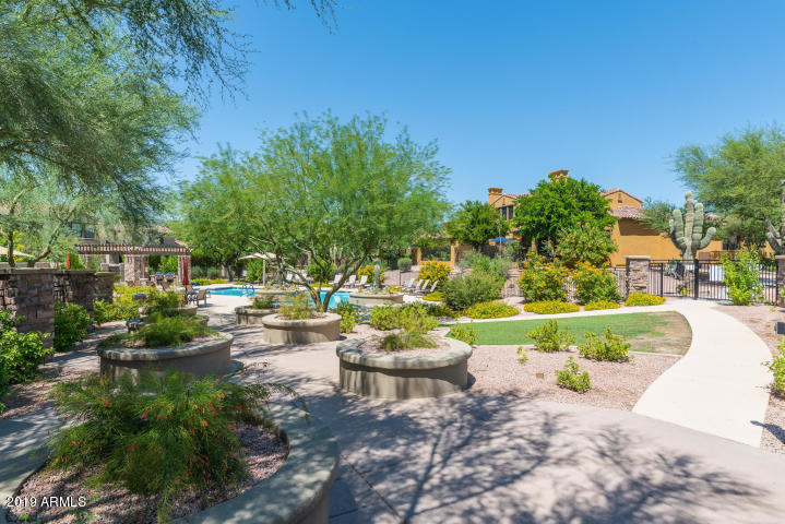 20750 North 87th Street, Unit 1123 Scottsdale, AZ 85255 - Photo 27 of 32 a view of a swimming pool with a patio and a garden