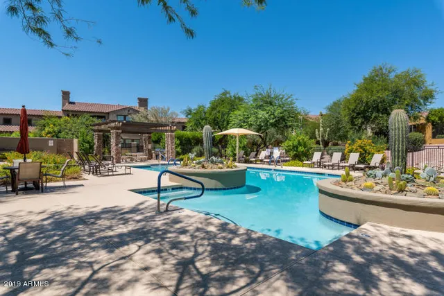a view of a swimming pool with a patio