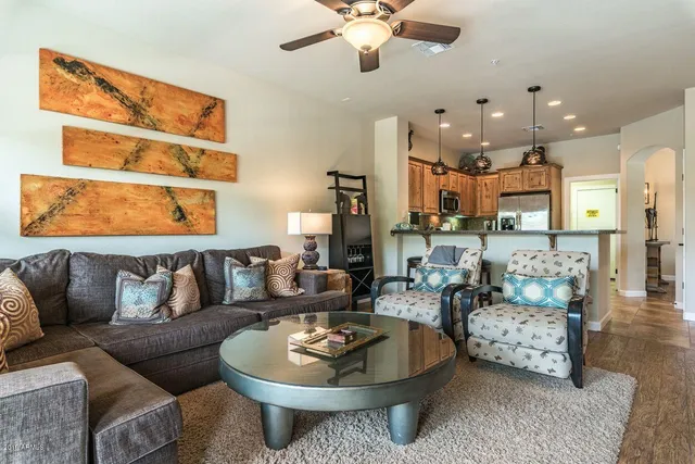 a living room with furniture kitchen and a chandelier