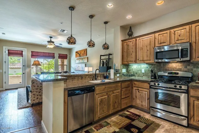 a kitchen with a sink stove and microwave