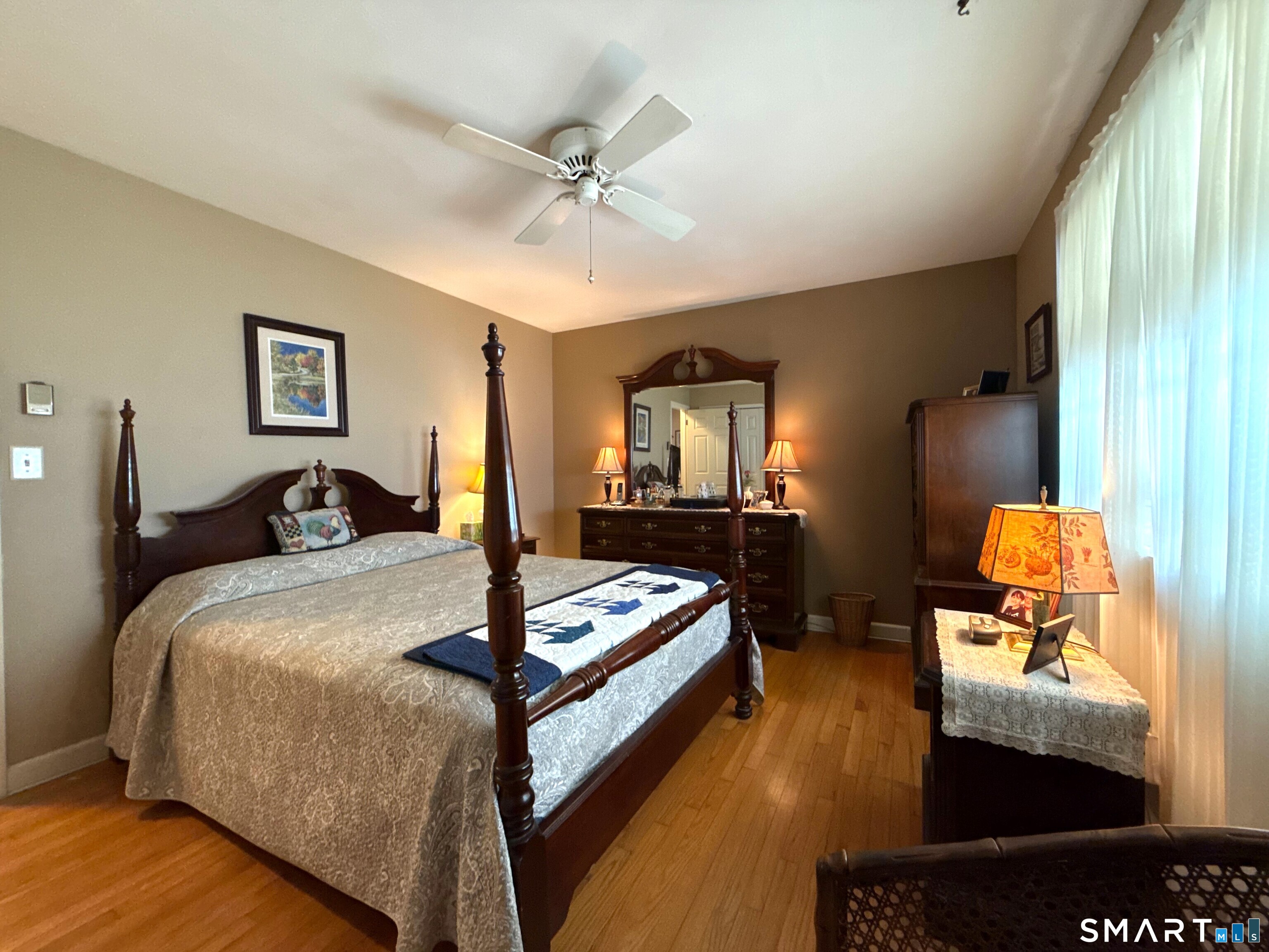 15 Grove Street Deep River, CT 06417 - Photo 13 of 25 a bedroom with a bed and wooden floor
