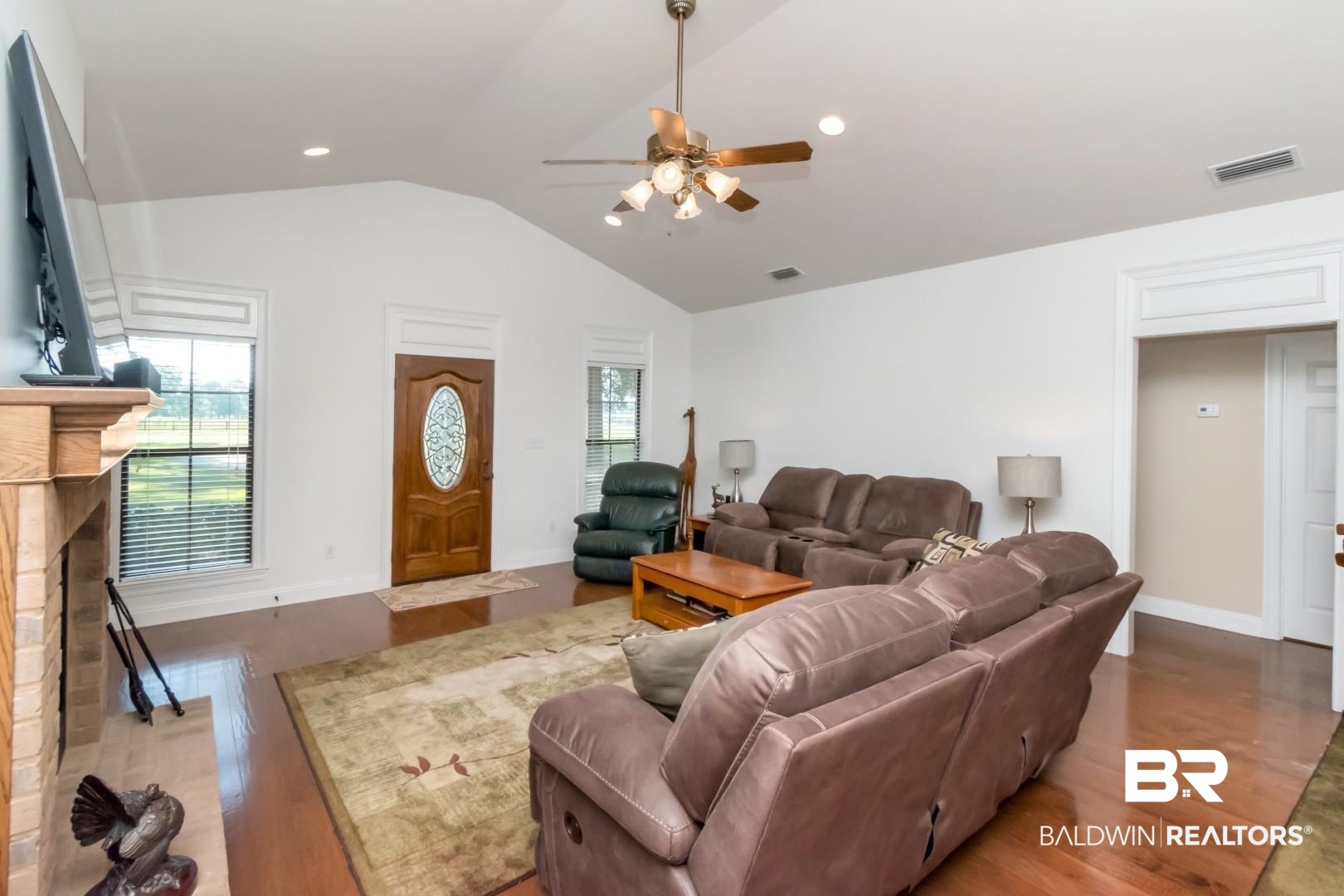 1360 Dykes Road North Mobile, AL 36608 - Photo 6 of 40 Living area with a brick fireplace, vaulted ceiling, wood finished floors, a ceiling fan, and recessed lighting