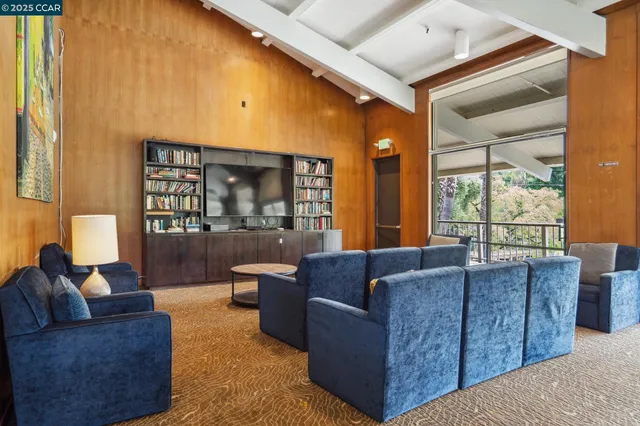 a room with pool table and windows
