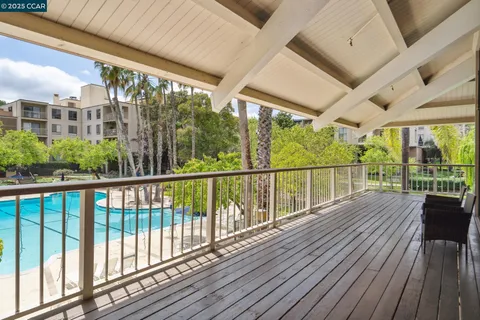 a view of a swimming pool with a lawn chairs