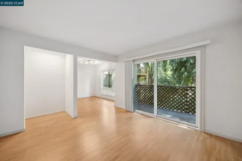 a view of a room with wooden floor and windows