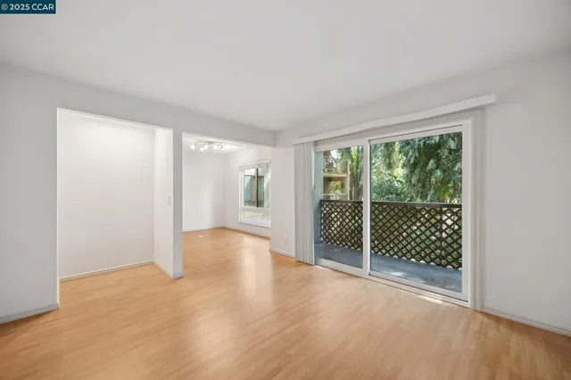 a view of a room with wooden floor and windows
