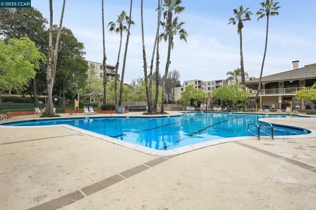 a view of a lake with a table and chairs under an umbrella