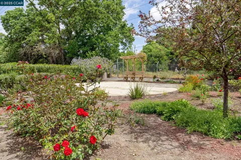 a view of a house with pool and a yard