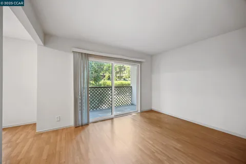 a view of a room with wooden floor and balcony