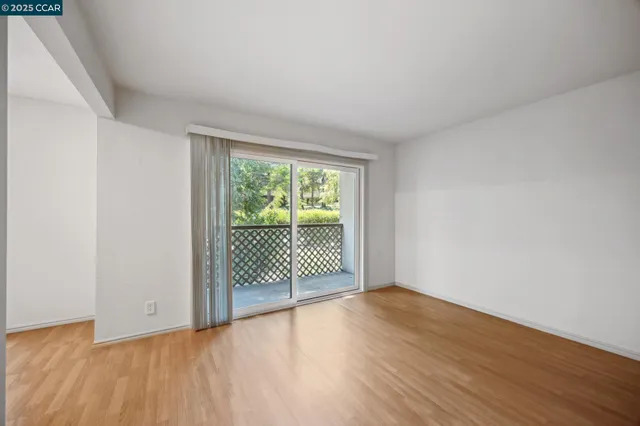 a view of a room with wooden floor and balcony