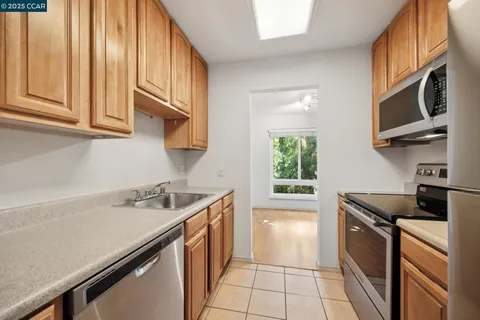 a kitchen with stainless steel appliances granite countertop a stove microwave and refrigerator