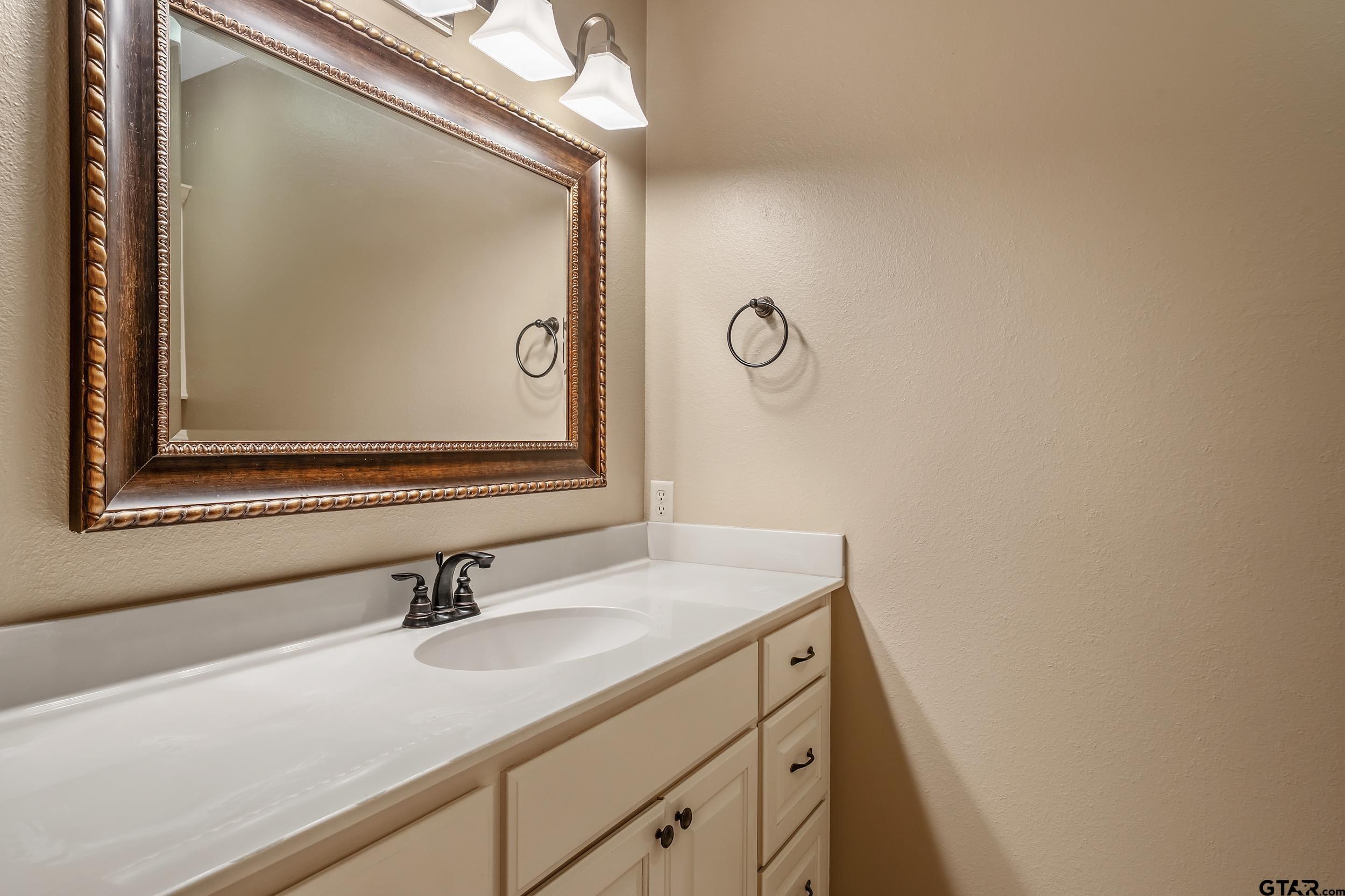 3056 Cornerstone Trail Tyler, TX 75701 - Photo 16 of 24 a bathroom with a sink and a mirror