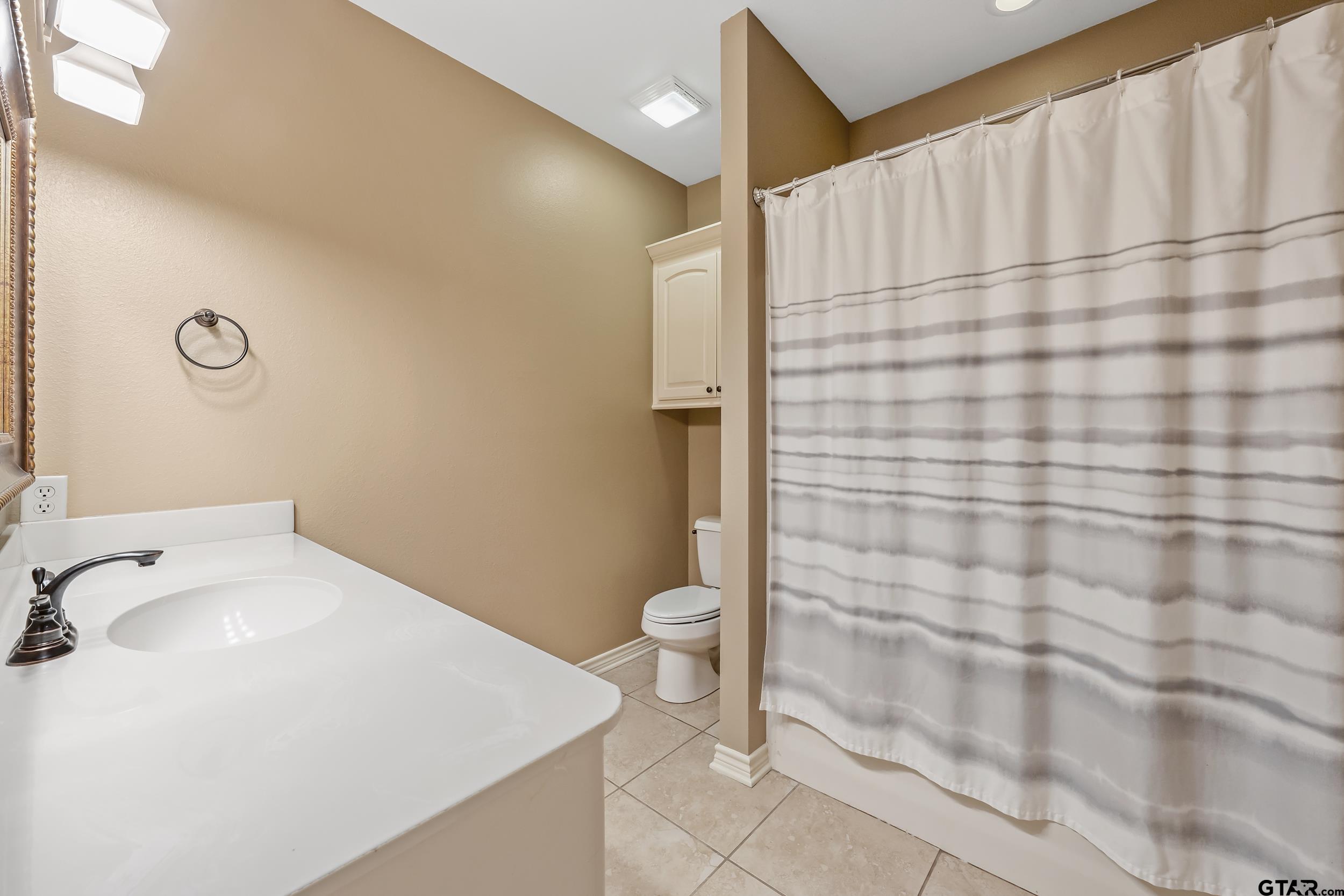 3056 Cornerstone Trail Tyler, TX 75701 - Photo 17 of 24 a bathroom with a sink a toilet and shower