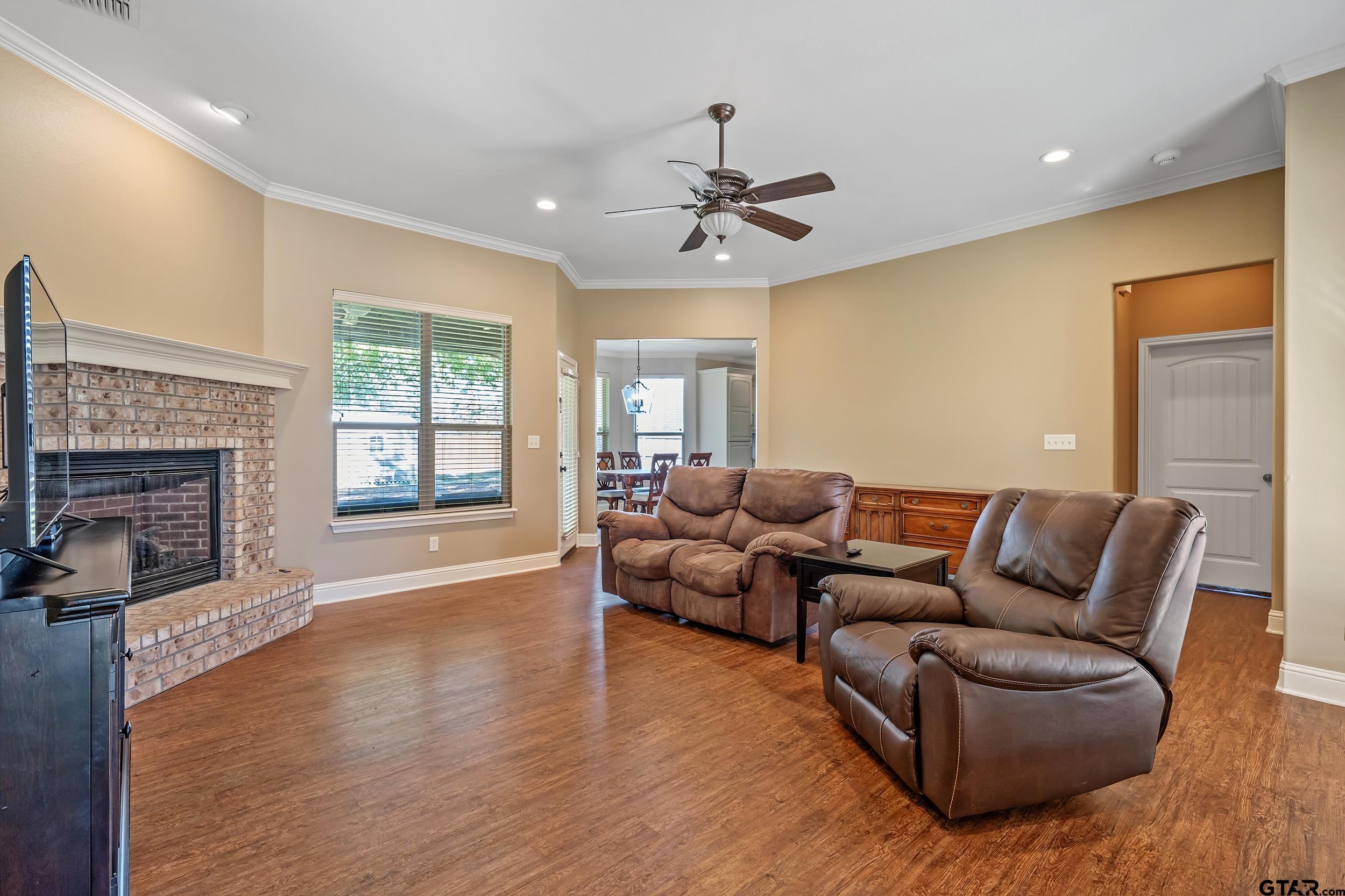 3056 Cornerstone Trail Tyler, TX 75701 - Photo 2 of 24 a living room with furniture a fireplace and a window