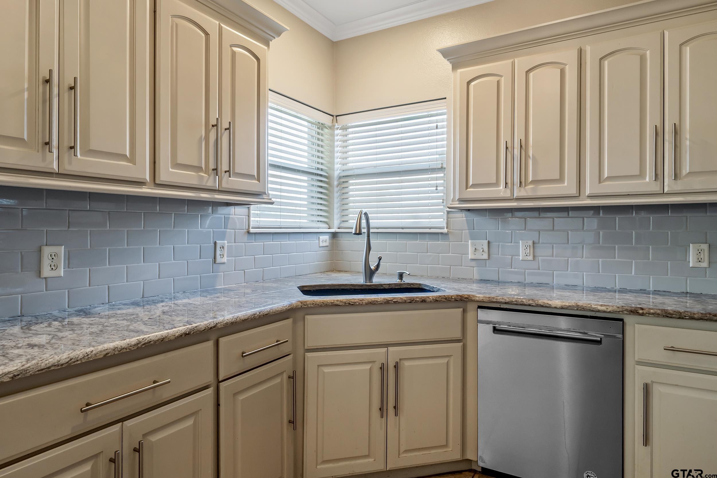 3056 Cornerstone Trail Tyler, TX 75701 - Photo 23 of 24 a kitchen with granite countertop white cabinets and a sink