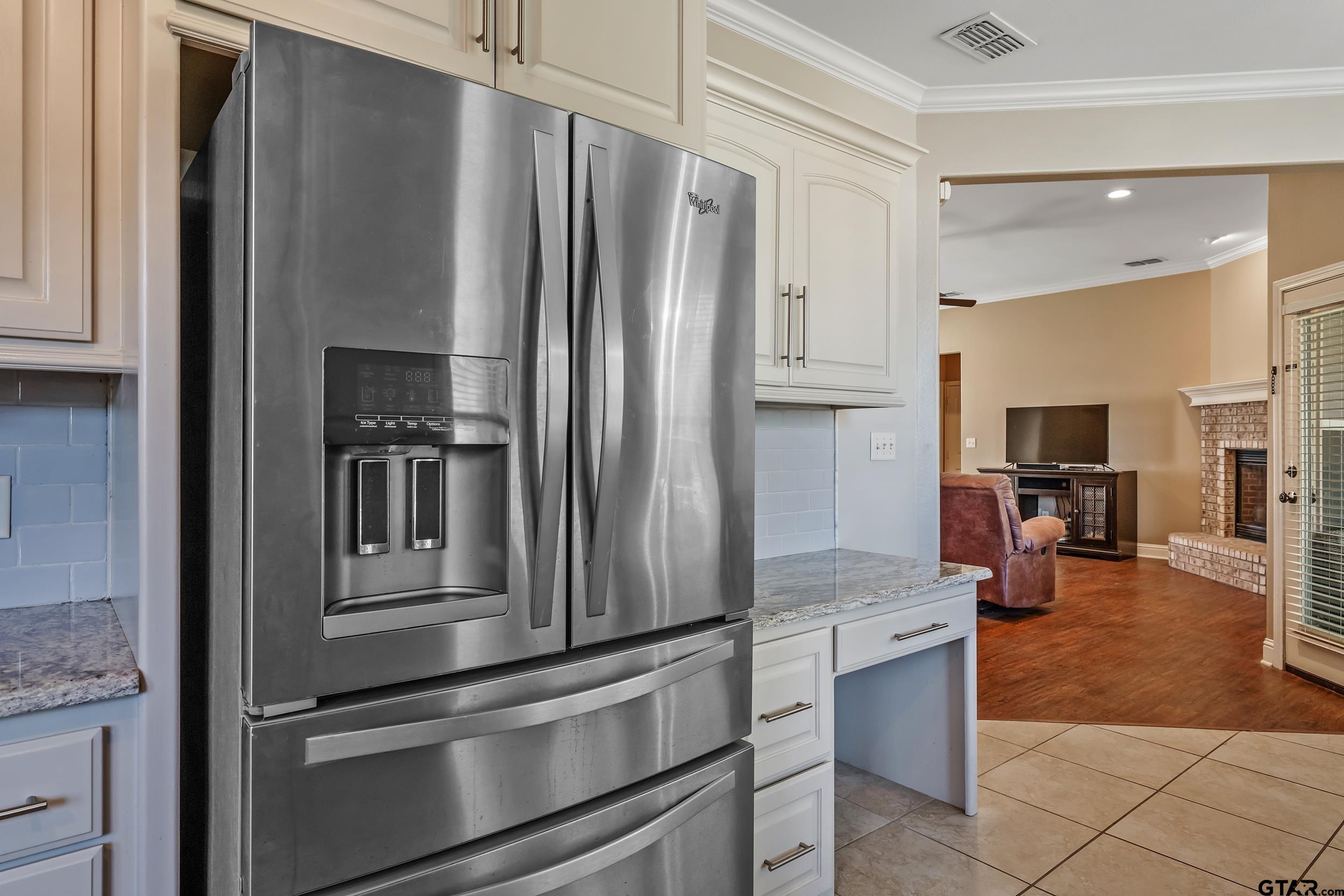 3056 Cornerstone Trail Tyler, TX 75701 - Photo 5 of 24 a kitchen with stainless steel appliances granite countertop a refrigerator and a sink