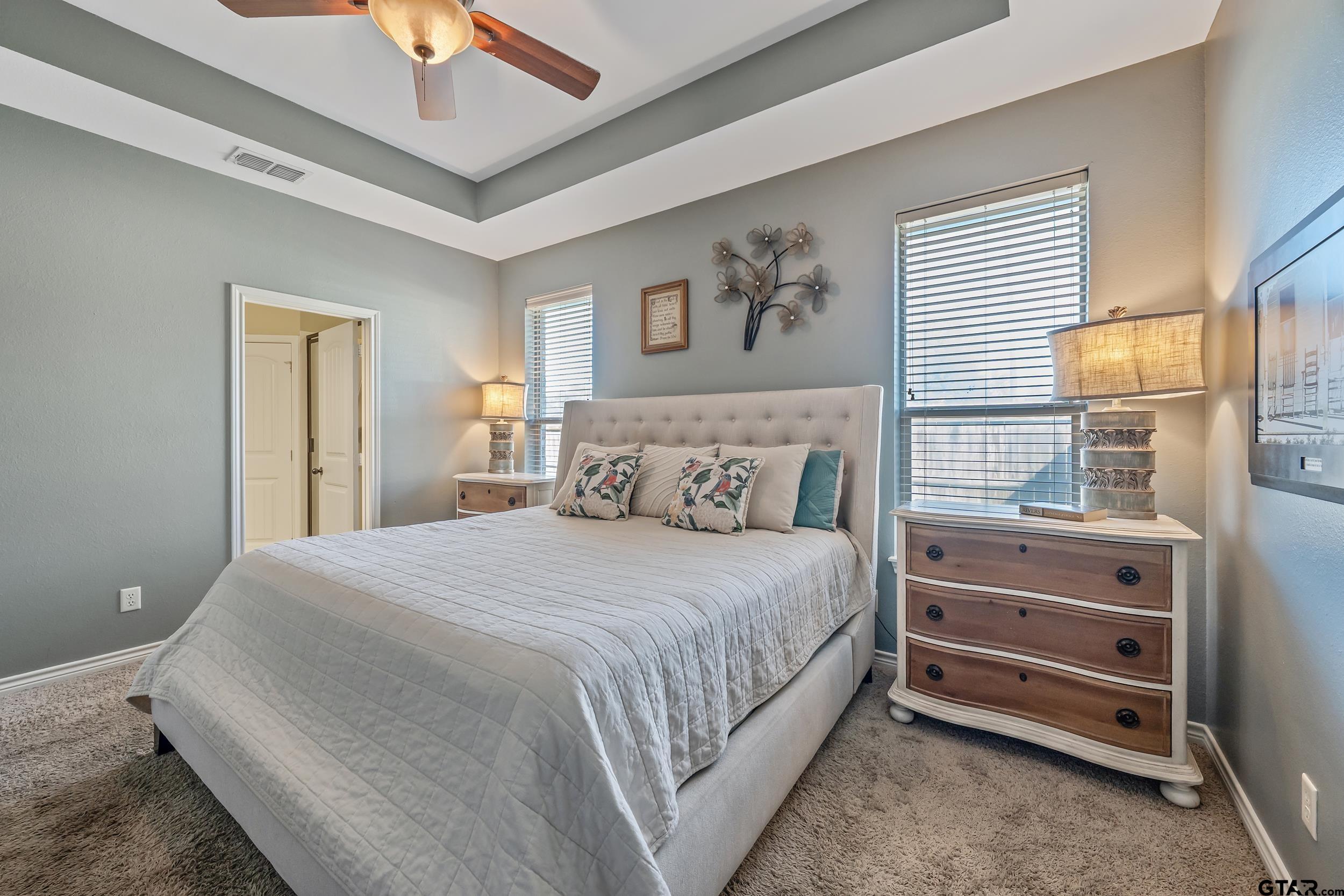 3056 Cornerstone Trail Tyler, TX 75701 - Photo 7 of 24 a bedroom with a bed and a chandelier