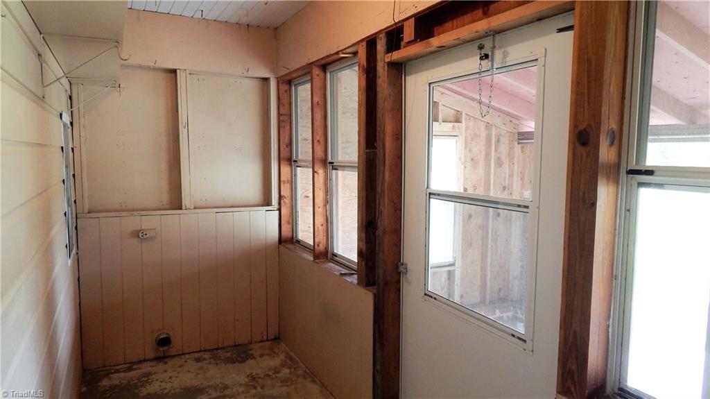 6719 Coltrane Mill Road Greensboro, NC 27406 - Photo 19 of 26 Rear enclosed porch adjacent to covered patio area & carport! Old laundry connections!
