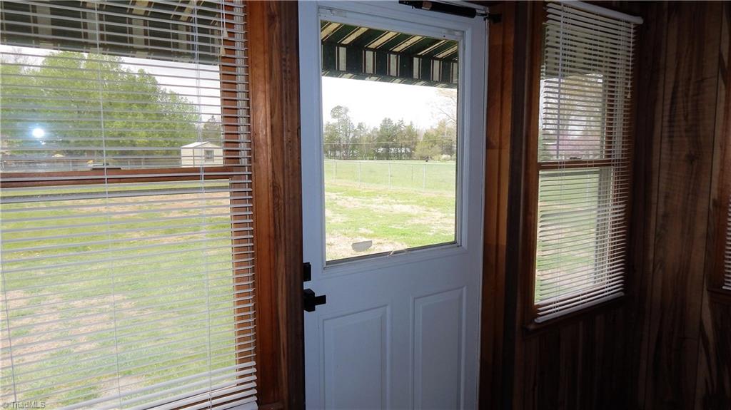6719 Coltrane Mill Road Greensboro, NC 27406 - Photo 23 of 26 Front enclosed porch by front door!