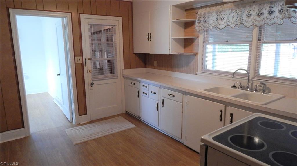 6719 Coltrane Mill Road Greensboro, NC 27406 - Photo 5 of 26 Kitchen w/deep porcelain sink & newer fixture! A door to the Dining Room & another to enclosed porch!