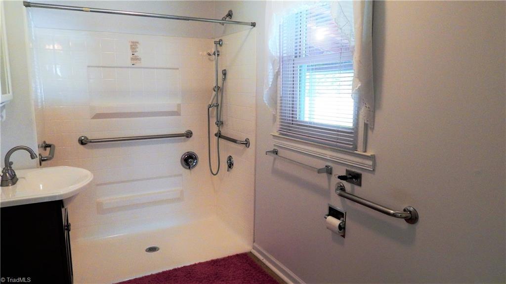 6719 Coltrane Mill Road Greensboro, NC 27406 - Photo 9 of 26 Full renovated Bath is handicapped accessible! Vinyl wood patterned flooring!