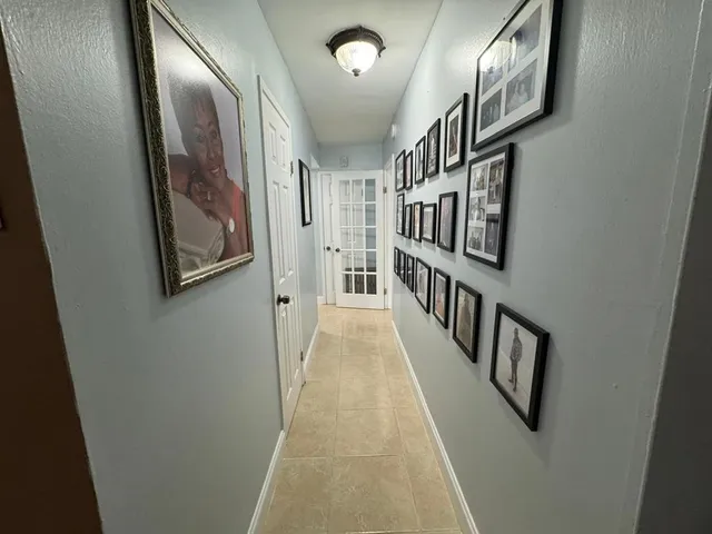 a bedroom with a bed and a flat tv screen on the dresser