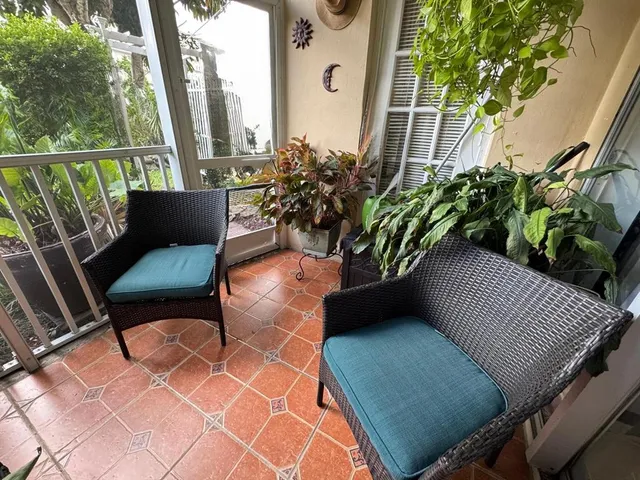 a view of a porch with potted plants