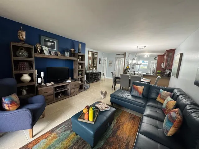 a view of a livingroom with furniture and a flat screen tv