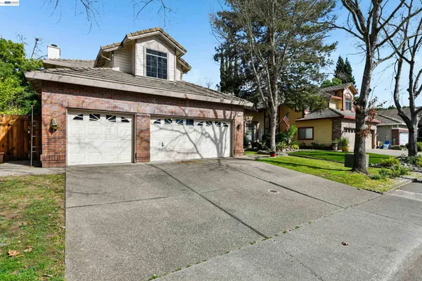 a view of a house with a yard and garage