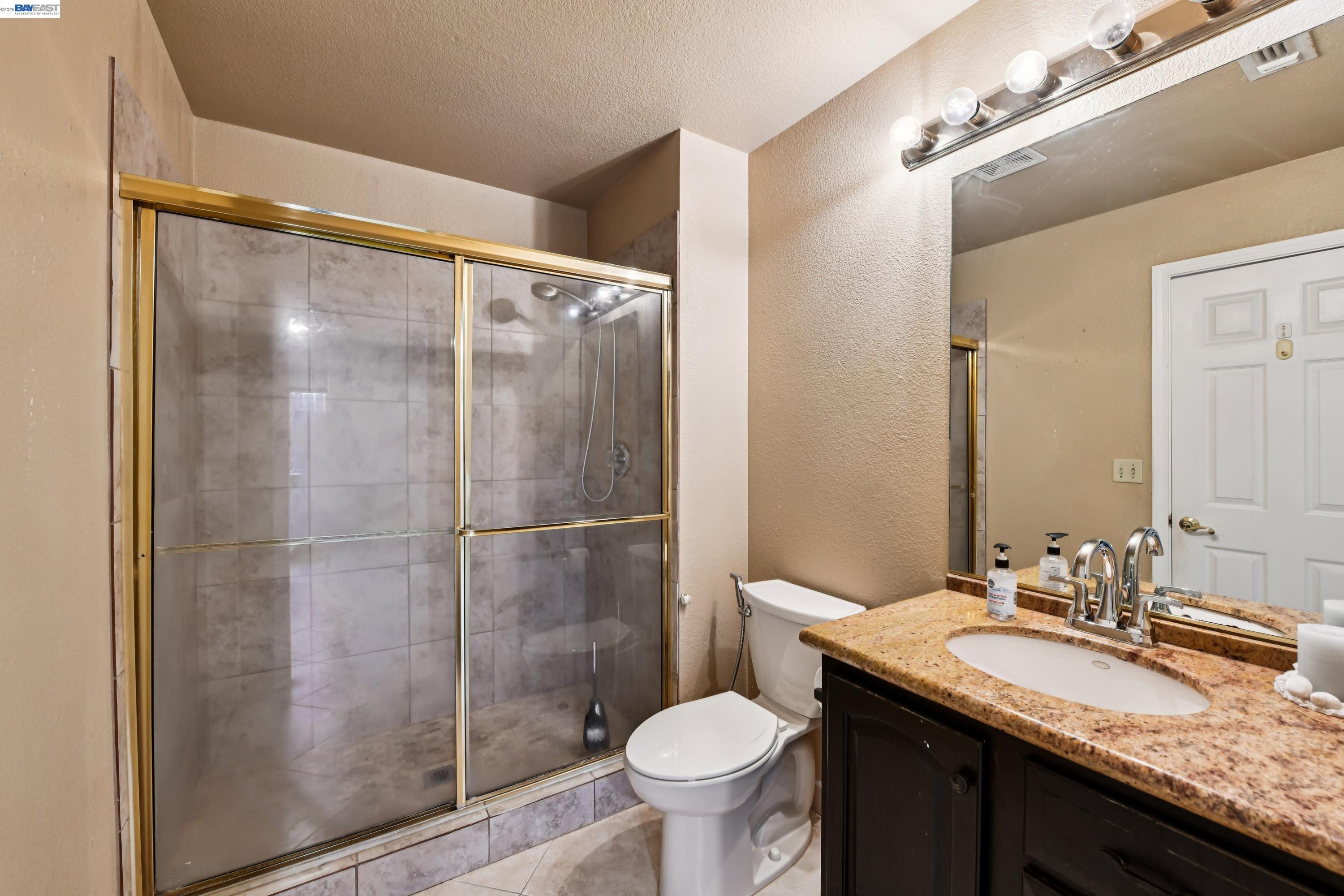 110 Conductor Way Folsom, CA 95630 - Photo 13 of 27 a bathroom with a granite countertop sink toilet and shower