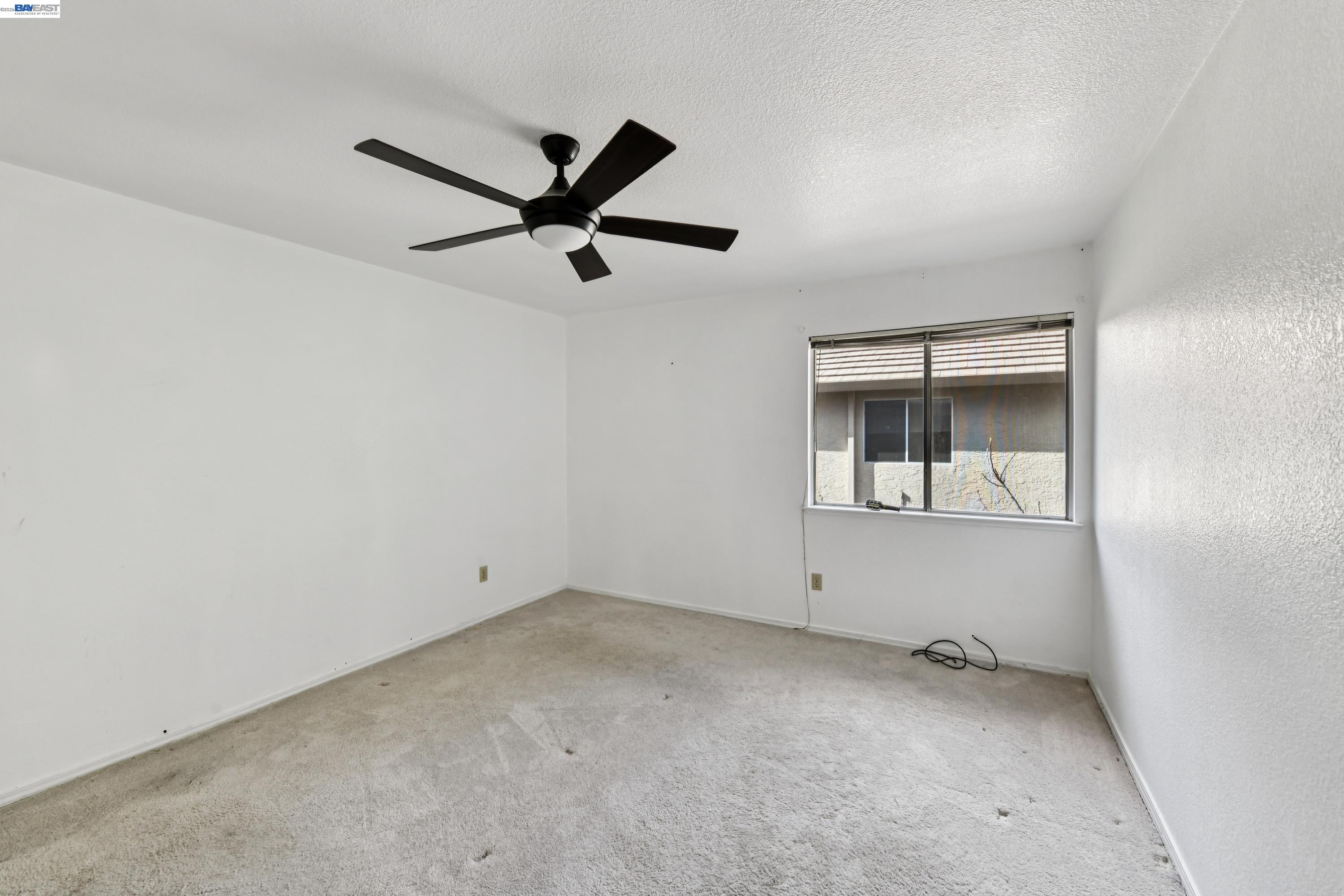 110 Conductor Way Folsom, CA 95630 - Photo 17 of 27 an empty room with a window and a ceiling fan